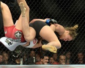 Champion Ronda Rousey, red, battles Miesha Tate, blue, during their Women’s Bantamweight Championship bout during UFC 168 at the MGM Grand Garden Arena in Las Vegas Saturday, December 28, 2013. Rousey beat Tate via round three arm bar. (Photo by Hans Gutknecht/Los Angeles Daily News